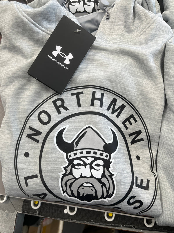 A folded gray Under Armour Northmen Hoodie circle crest by Sanderson Lacrosse, with a tag attached, featuring a Viking head logo and bold NORTHMEN and HOUSE text—a must-have for lacrosse fans.