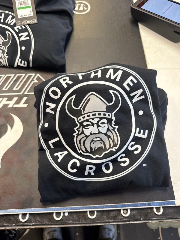 A folded black "Large circle Northmen logo" t-shirt from Sanderson Lacrosse features "Northmen Lacrosse" text and a Viking in a horned helmet at the center.