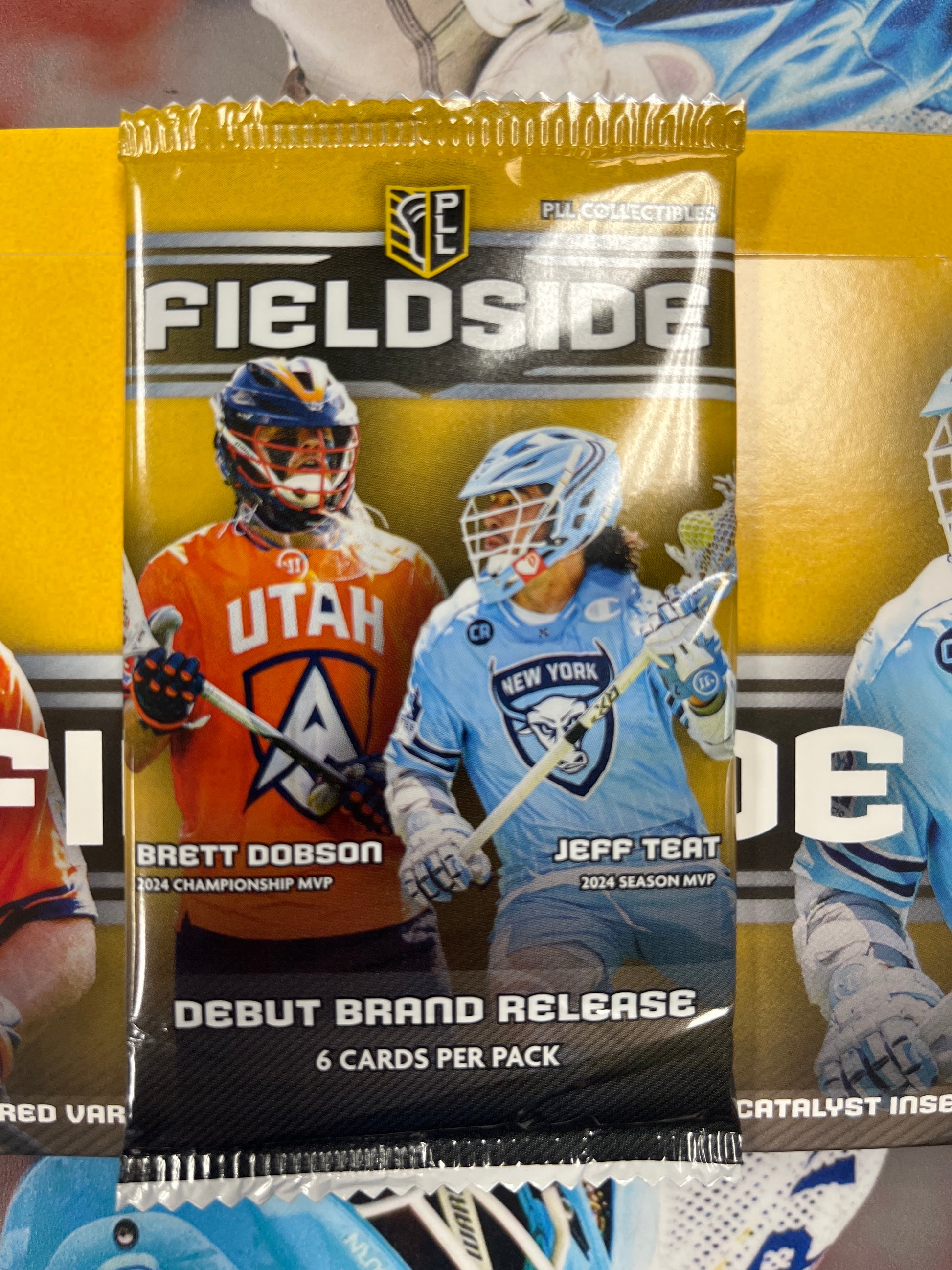 The 2025 Fieldside PLL Collector Cards – Single Pack by PLL showcases Brett Dobson and Jeff Teat on the front, with "Debut Brand Release" and "6 Cards Per Pack" text.