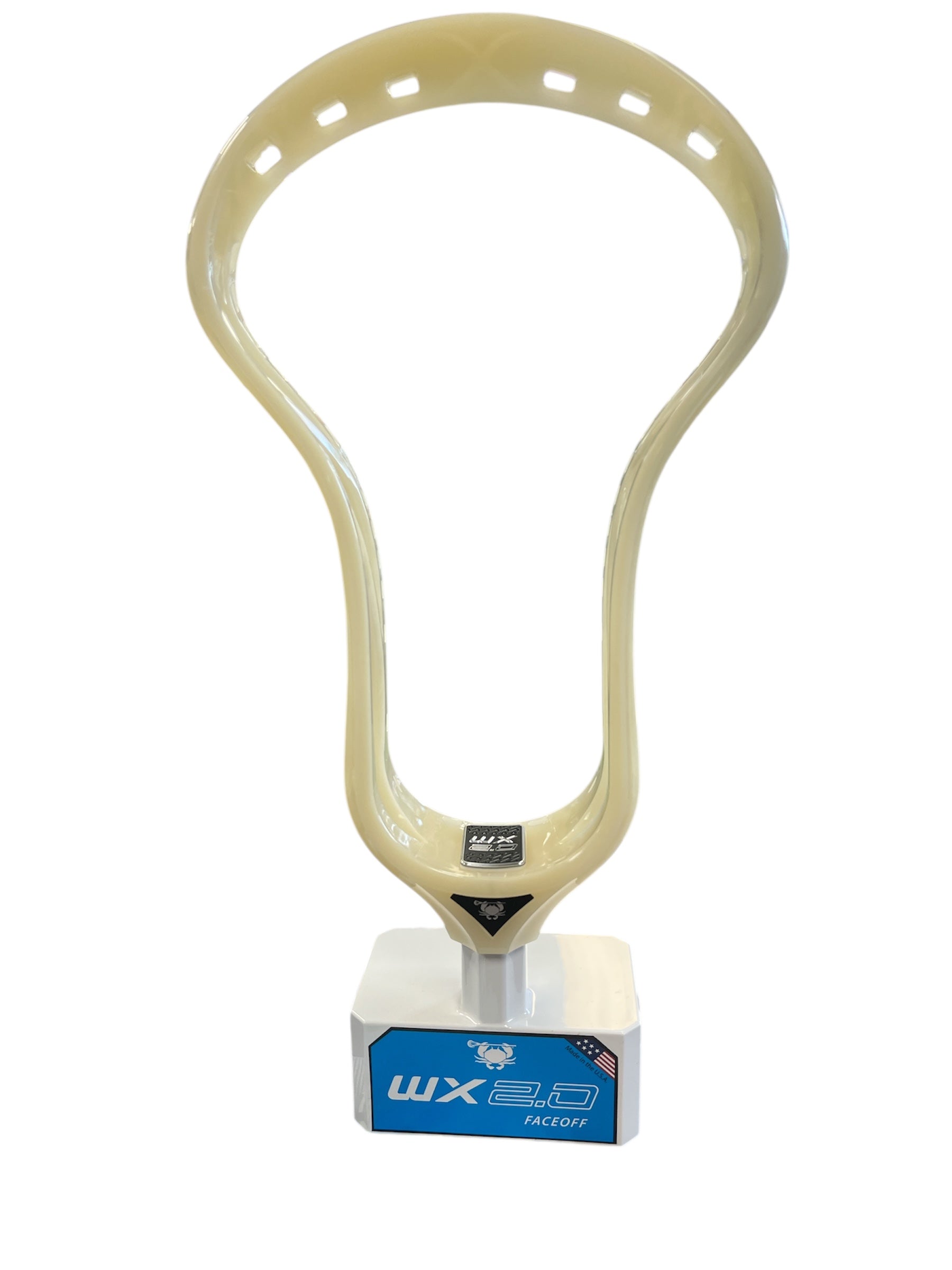A beige Sanderson Lacrosse ECD WX 2.0 Faceoff Lacrosse Head stands upright with oval holes along the top edge, attached to a white and blue display stand. The product is set against a plain white background.