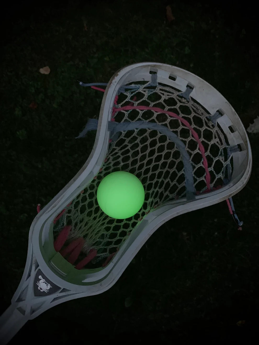 The Firefly Glow in the Dark Lacrosse Balls 3-pack, including a black light flashlight, from Firefly shines vividly in your lacrosse stick—perfect for nighttime games and easy visibility on dark fields.