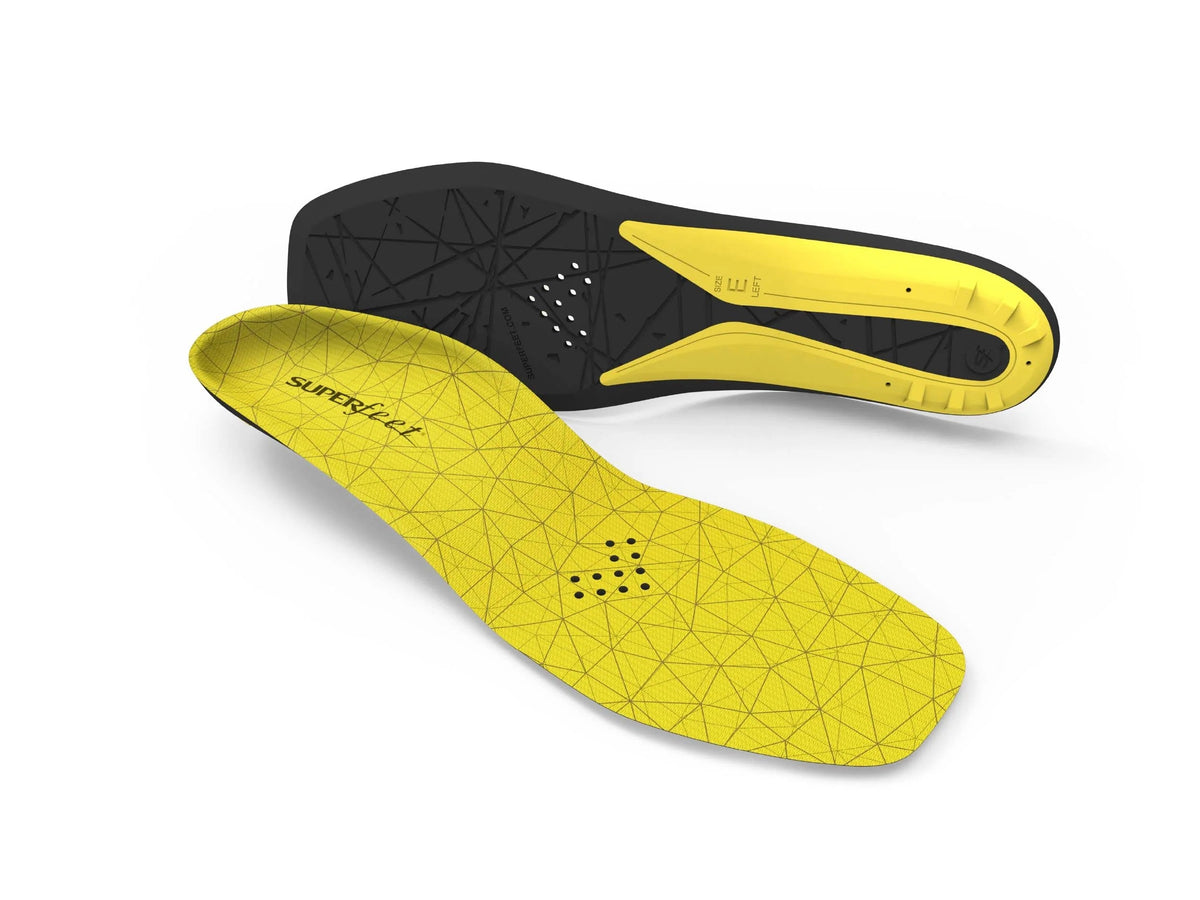 A pair of Superfeet Hockey Cushion insoles by Superfeet, featuring yellow and black geometric patterns and ventilation holes for foot stability—shown from both top and bottom views.