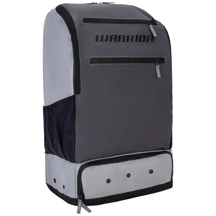 The Warrior Jet Pack Q10Max4 Lacrosse Backpack by Warrior features a grey and black design, two front zip pockets, a spacious main compartment, side pocket, stick loops, and a vented lower section—ideal for carrying sports or hockey gear.