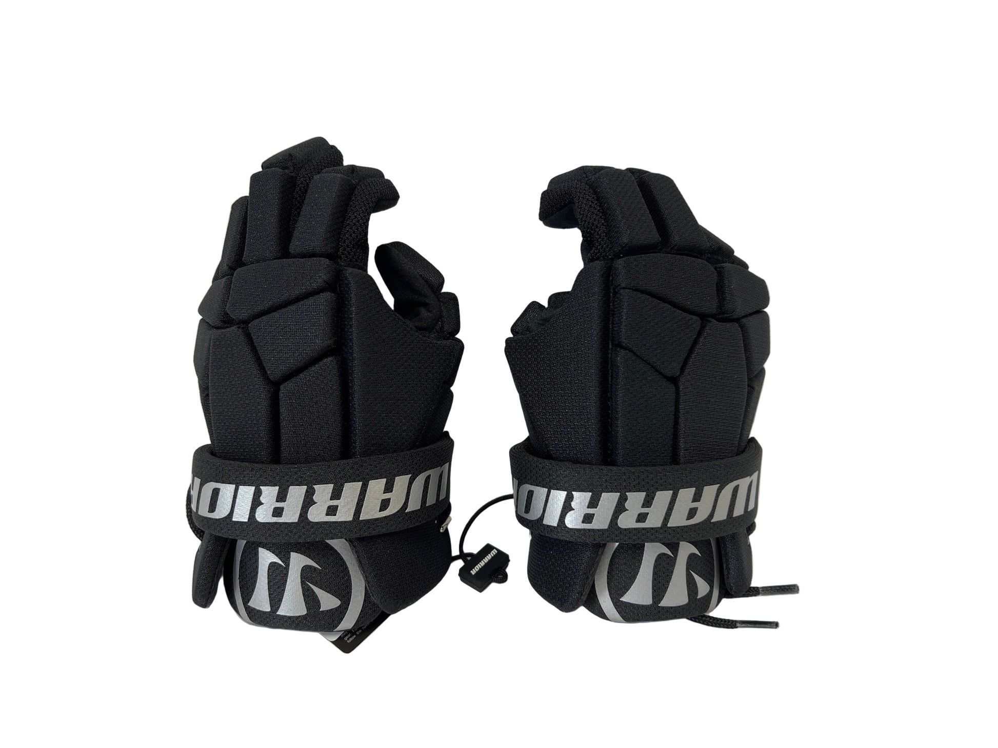 The Sanderson Lacrosse Warrior Next Lacrosse Gloves are black, padded, and feature segmented protective padding with “WARRIOR” in white across the wrist straps.