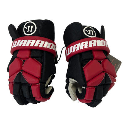 A pair of Warrior Fatboy Lacrosse Gloves from Sanderson Lacrosse, featuring black and red design with white logos and "WARRIOR" on the wrist straps—ideal protective gear for lacrosse players.
