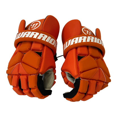 A pair of bright orange Sanderson Lacrosse Warrior Fatboy Lacrosse Gloves with white branding across the straps, shown against a white background—ideal protective gear for intense lacrosse play.