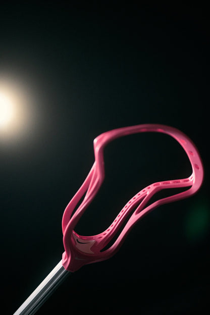 Nike Surge Elite lacrosse head in limited edition Pink on a dark studio background