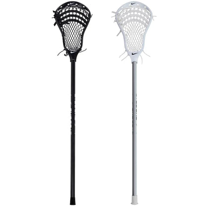 Two Nike Surge LT Complete Attack Lacrosse Sticks, one black and one white with mesh pockets and a Nike logo, stand upright against a white background. This stick is ideal for beginners looking for a quality lacrosse experience.