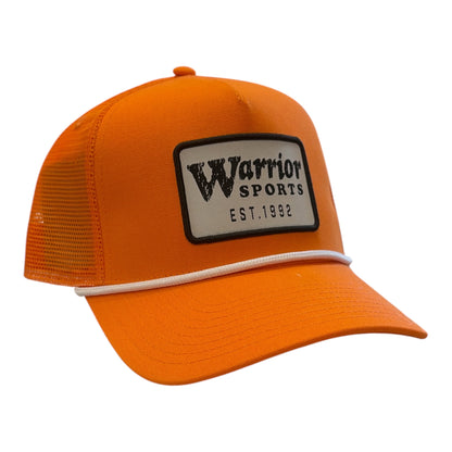 Warrior Novium Cabin Fever Trucker Hat in orange with mesh back, white rope brim detail and Warrior Sports patch